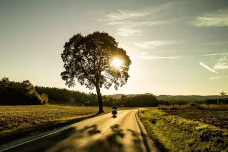 A man riding a motorbike in a clear, sunny weather backdrop